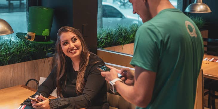 temporary worker taking woman's order at a restaurant