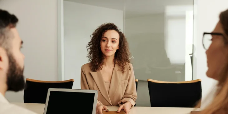 A woman being interviewed by recruiters.