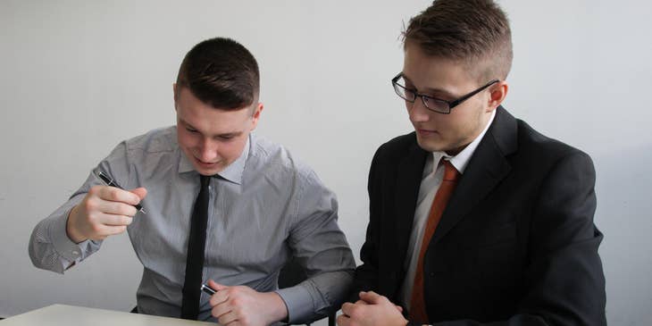 An HR coordinator issuing an employment contract to sign over.