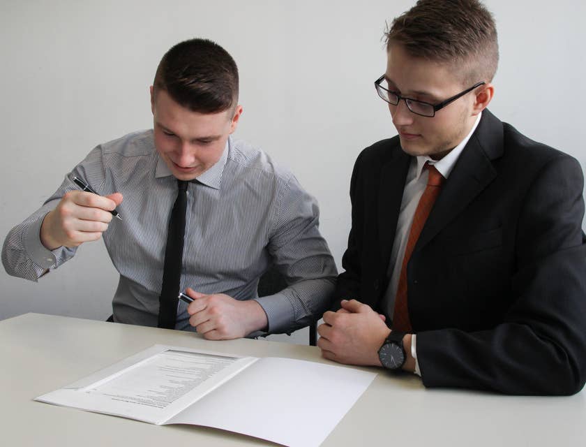 An HR coordinator issuing an employment contract to sign over.