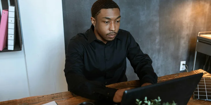 An HR representative working on his laptop.