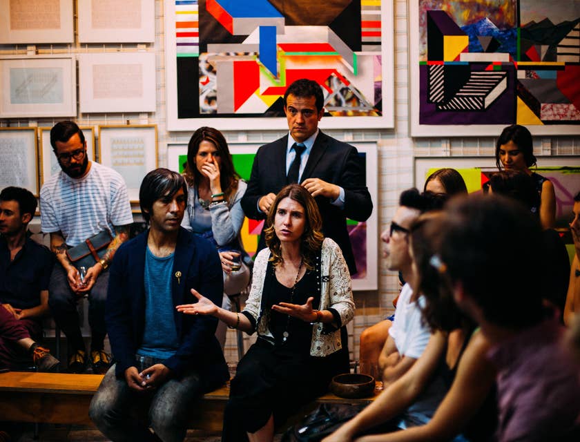 A Human Rights Advocate in a suit attending a human rights meeting to observe and gather information on people's interest.