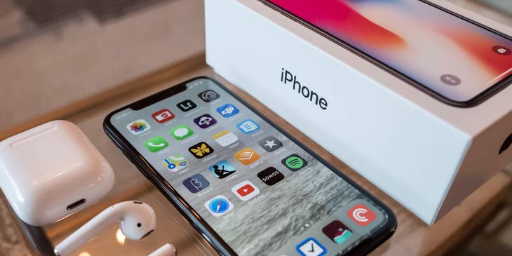 A new iOS iPhone displayed next to its packaging.