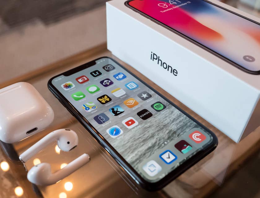 A new iOS iPhone displayed next to its packaging