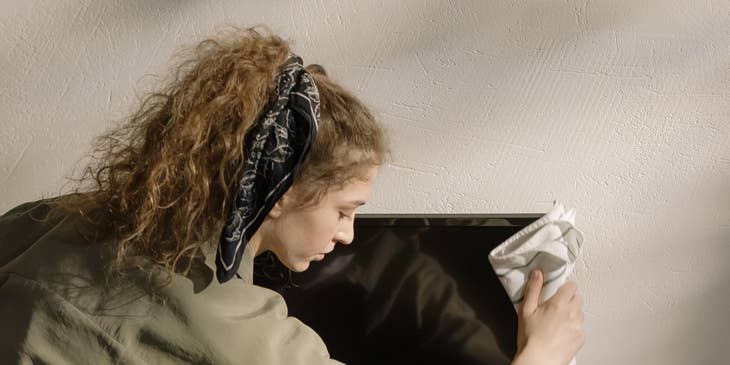installer wiping down a newly installed flat screen tv
