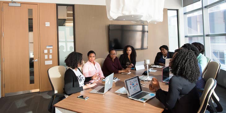 female Investment Consultant having a meeting with her clients inside an office room during daytime