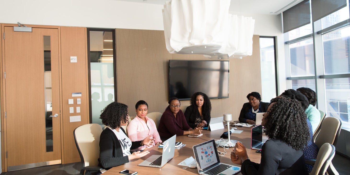 female Investment Consultant having a meeting with her clients inside an office room during daytime