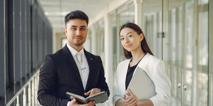 two IT Consultants standing in the hallway to meet their clients and present their recommendations