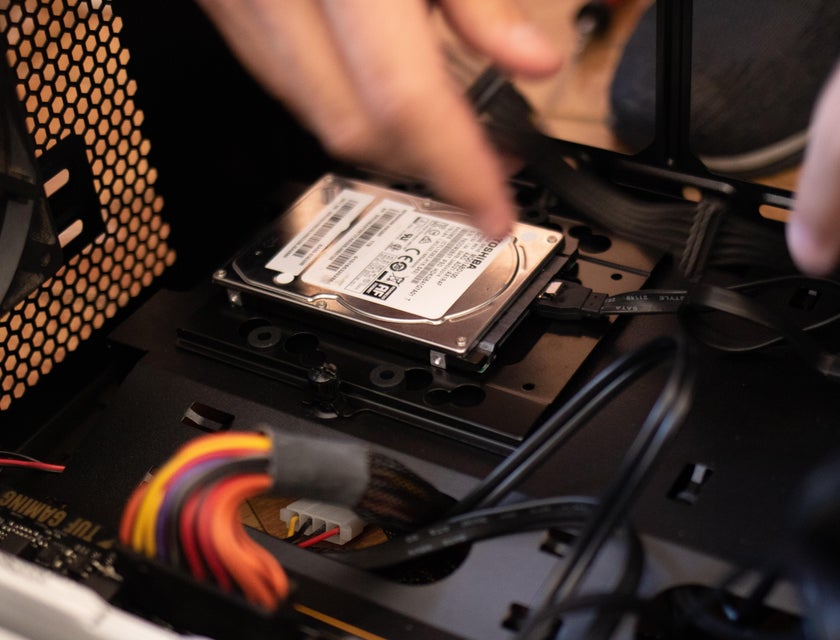 IT Specialist installing a hard disk on one of his client's workstations