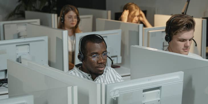 a team of IT Support Engineers taking in troubleshooting calls over the phone regarding network issues