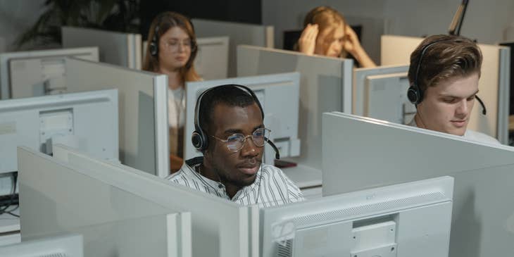 a team of IT Support Engineers taking in troubleshooting calls over the phone regarding network issues