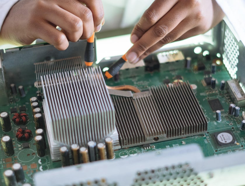IT Technician doing maintenance check on a motherboard