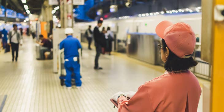 Janitorial Supervisor holding a clipboard on a station