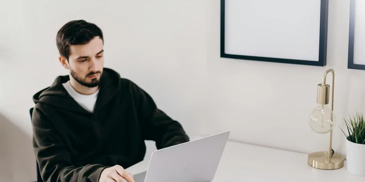 A Java software engineer looking at a laptop.