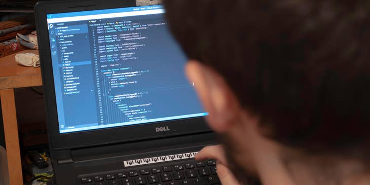JavaScript Developer finalizing the software design on his laptop