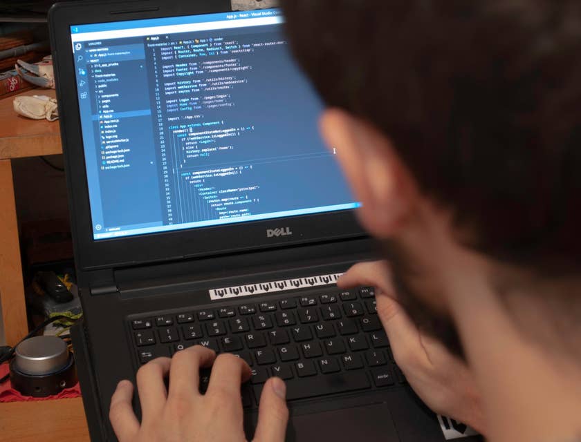 JavaScript Developer finalizing the software design on his laptop