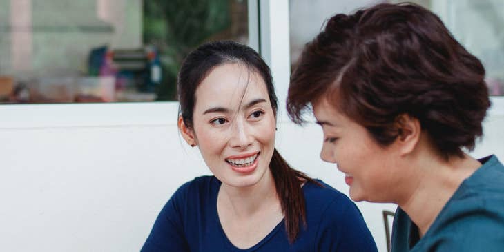 Two women working on a job description template.