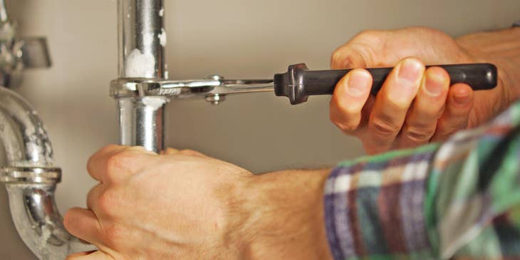 Journeyman plumber repairing a pipe