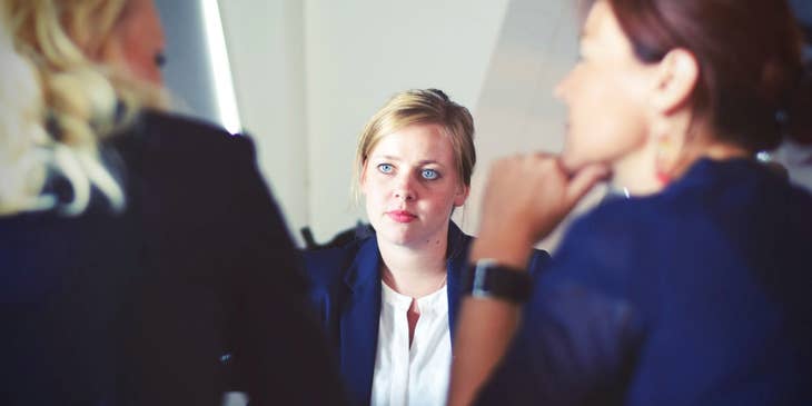 Junior Project Manager listening in a meeting with Project Managers