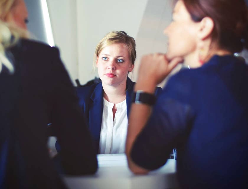 Junior Project Manager listening in a meeting with Project Managers