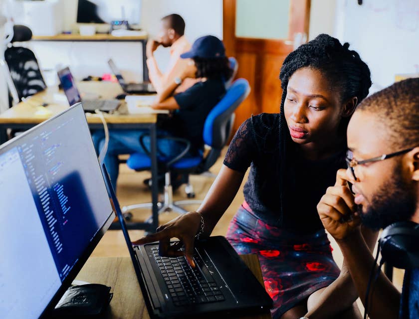 Junior software developer being shown by his team leader the details of the project that needs to be prioritized