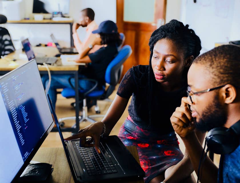 Junior Software Developer being shown by his team leader the details of the project that needs to be prioritized