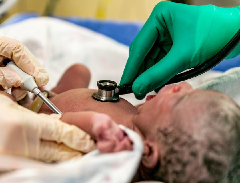 Labor and delivery nurse performing tests on newborns after birth.