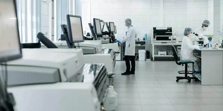 A laboratory manager with other laboratory technicians.