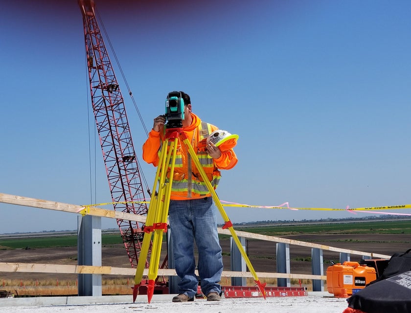 Land surveyor evaluates the construction site by using a special tool.