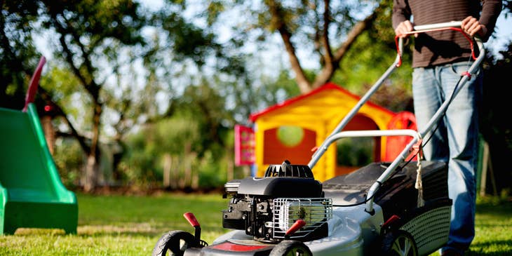 Lawn care specialist mowing a lawn.