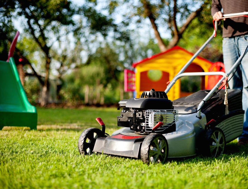 Lawn care specialist mowing a lawn.