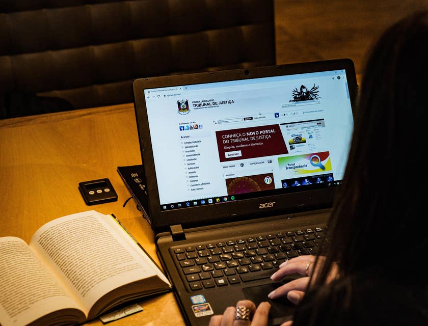 A female legal advisor researching regarding legal matters on a court of justice portal on her laptop.