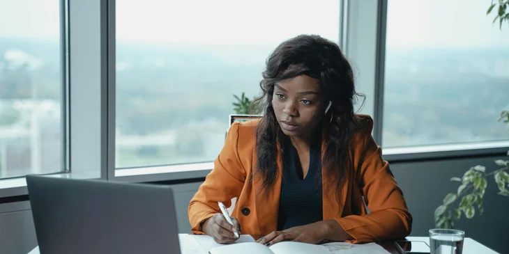A legal assistant doing legal research on her laptop.
