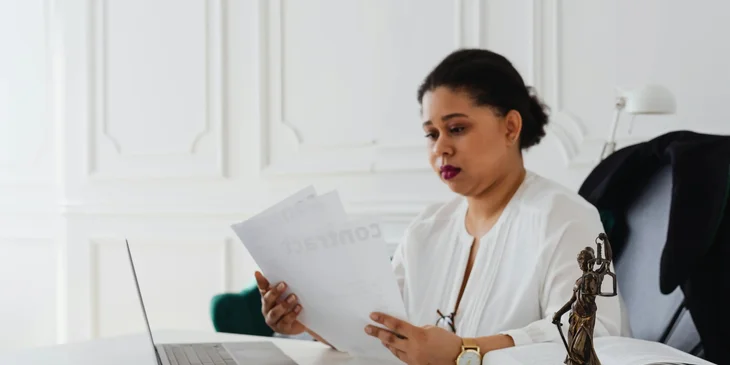 A legal secretary proofreading legal documents.