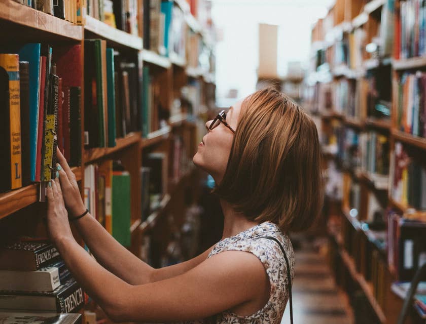 Library clerk re-shelving books