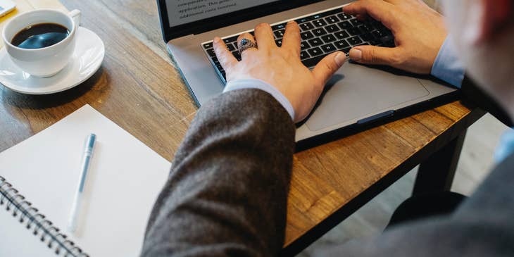 A litigation paralegal drafting a legal letter on his computer as instructed by an attorney.