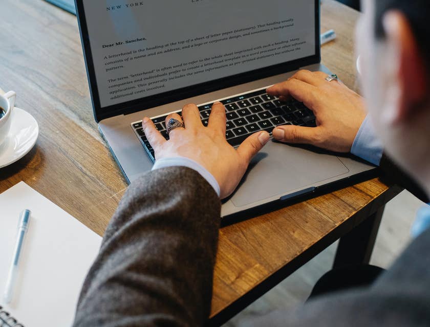 A litigation paralegal drafting a legal letter on his computer as instructed by an attorney.