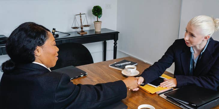 Lobbyist shaking the hand of her constituent after their closed-door meeting