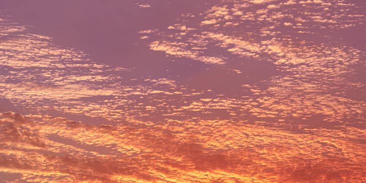 Sunset with a pink hue along Long Beach, California.