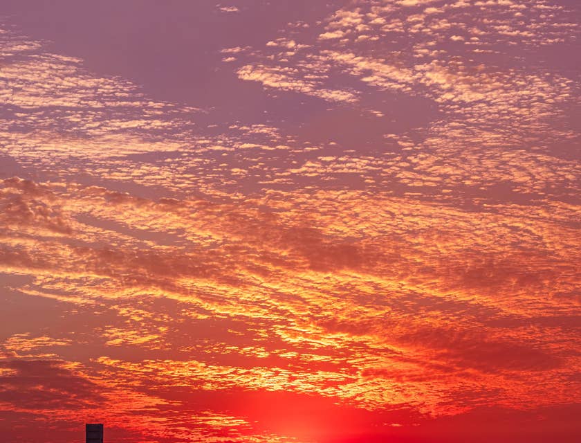 Sunset with a pink hue along Long Beach, California.