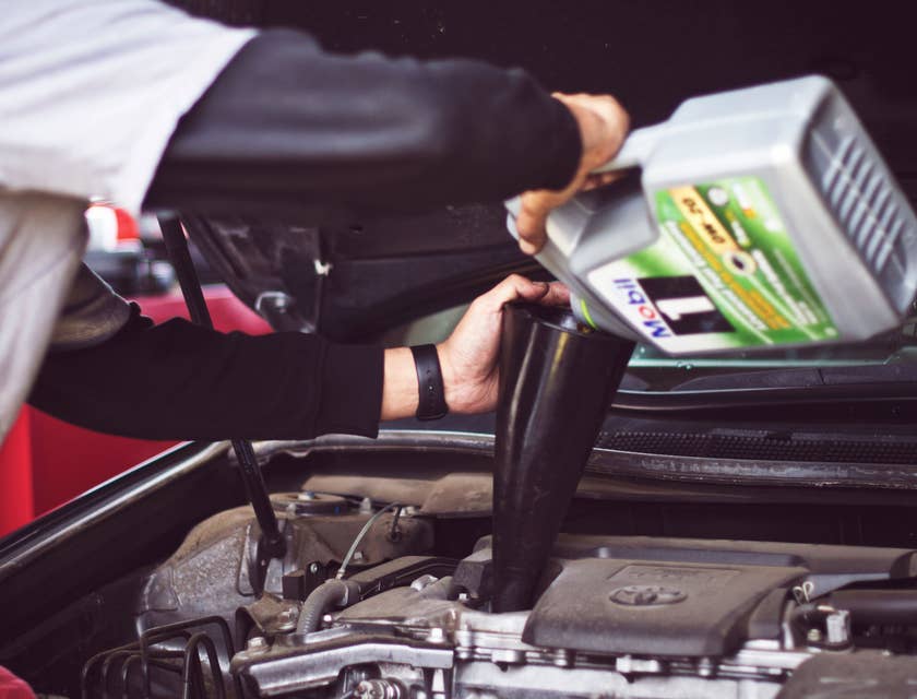 Lube Technician changing motor oil on a car