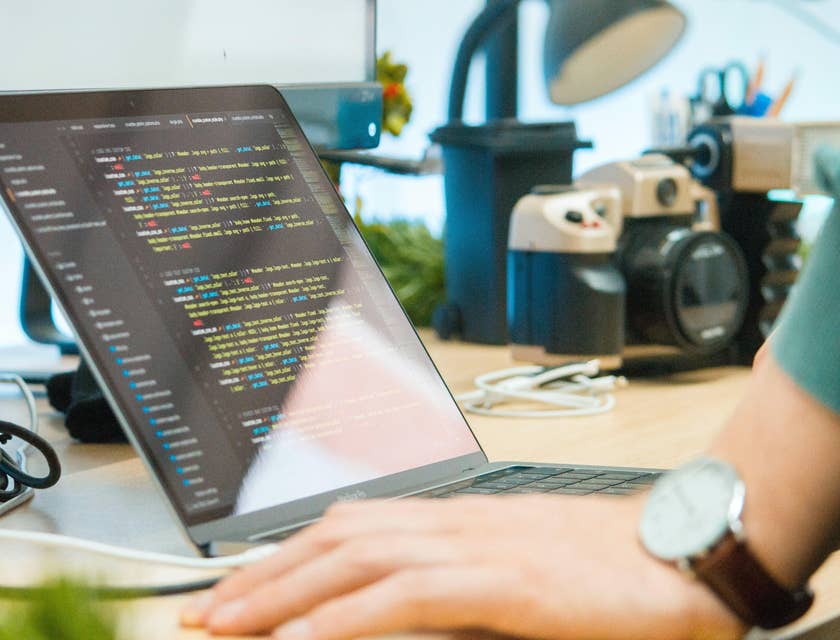 Machine Learning Engineer finishing his AI software program using his laptop