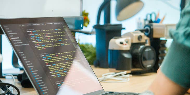 Machine learning engineer finishing his AI software program using his laptop