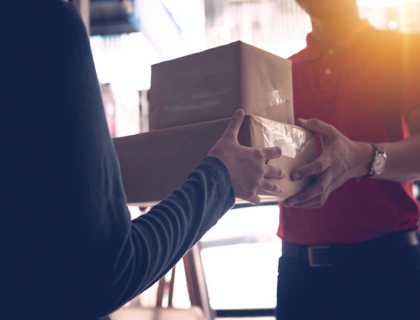 Mail clerk delivering a package to a women in a building