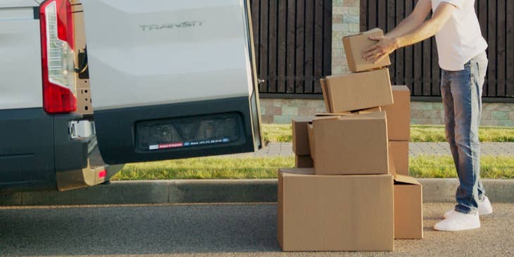 Mail handler assistant unloading bulk mail from a van