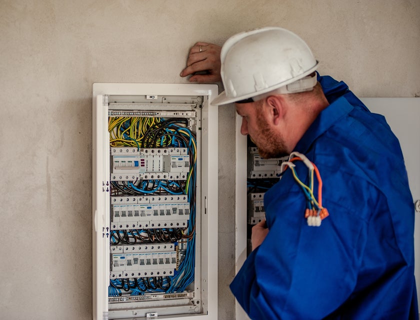 Maintenance electrician repairing a building's electric panel box