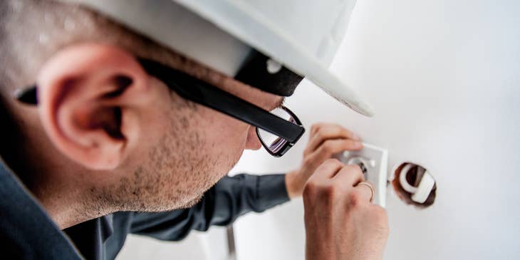 Maintenance Worker repairing an electrical outlet
