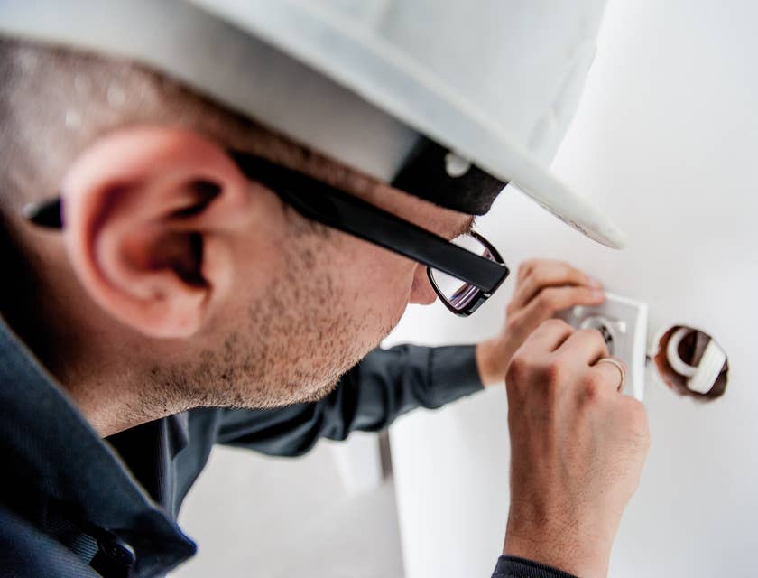 Maintenance worker repairing an electrical outlet