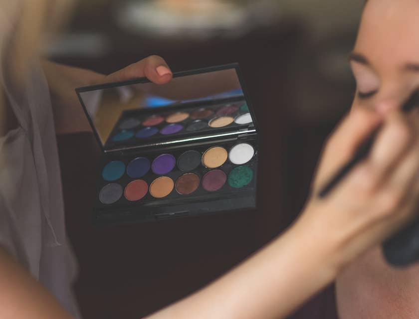 Makeup Artist applying eyeshadow on a client.