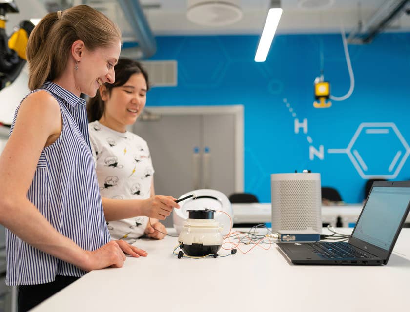 Manufacturing Engineers testing a new product while standing next to the table with an open laptop